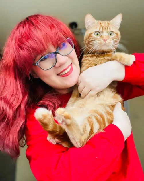 red haded girl with a cat